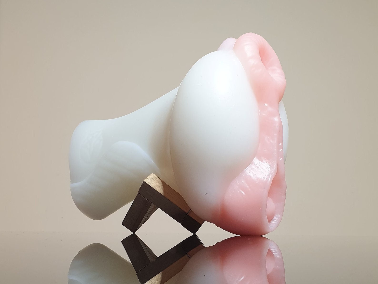 A side view of a white horse themed masturbator with pink pussy lips, modelled on a mare.